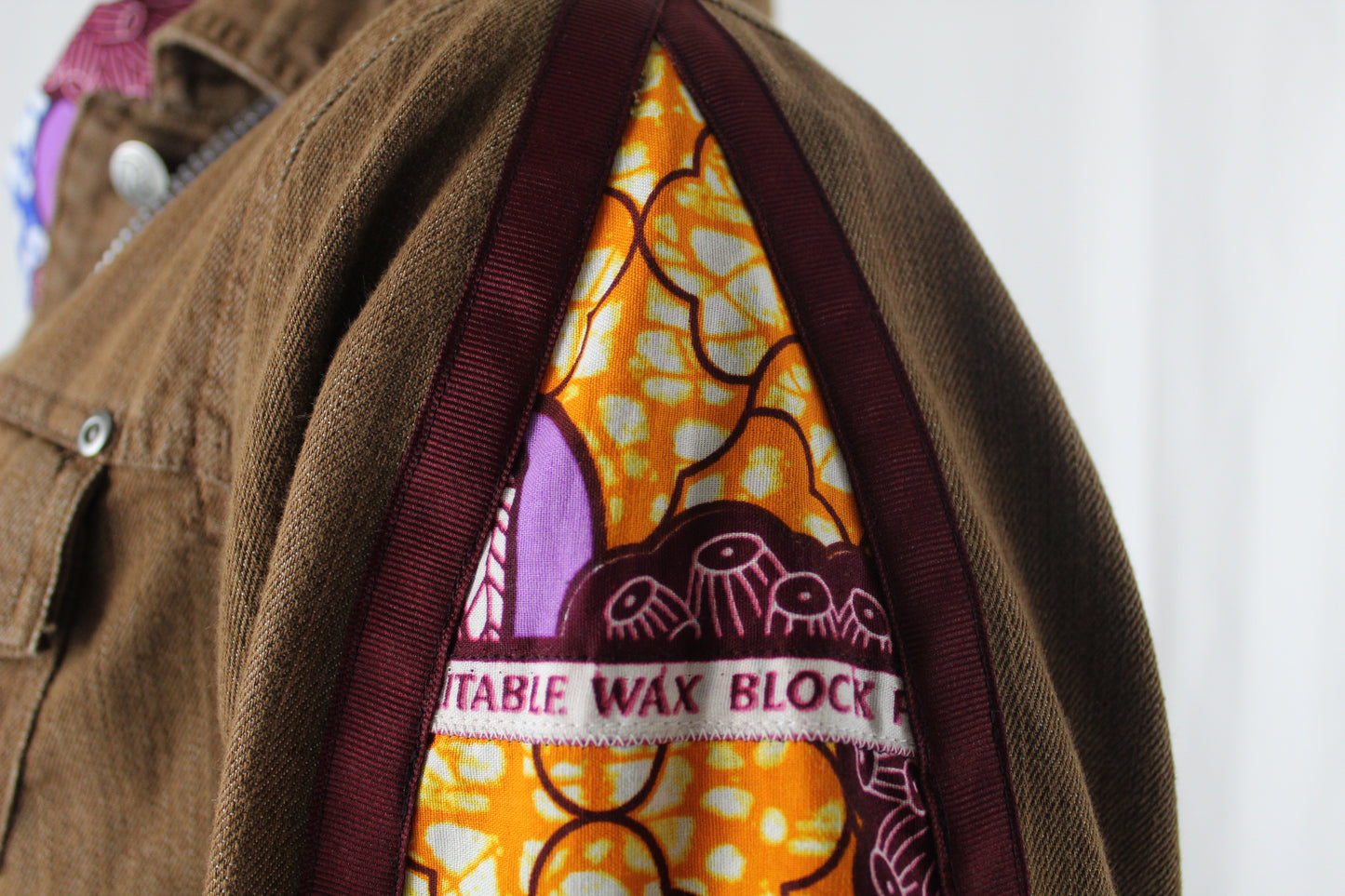 Upcycled jean jacket 12W Leather Applique Agyinduwura symbol & Ankara brown denim One-Of-A-Kind African Diaspora